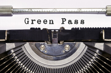 words 'Green Pass' typed on vintage typewriter.Pandemic Covid 19 period. The COVID-19 green pass certification facilitates travel to Europe during the Covid 19 pandemic.