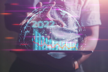 Businessman using a laptop that shows a graph of online investment trends yearly. Connect to a global network to process massive databases of components Digital Link 2022 Business Ideas
