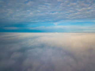 High flight over the fog. Aerial drone view.