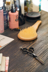scissors, comb and hair styling products in a beauty salon, blurred focus. High quality photo