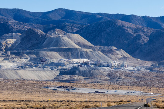 Industrial buildings built next to large tailing piles on a mountain in Gabbs Nevada