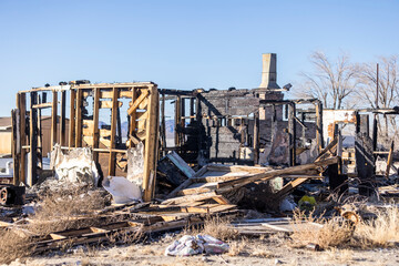 Fototapeta premium Charred pieces of a structure abandoned after a house fire