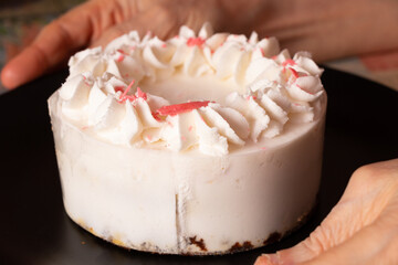 birthday cake on the table at home and mom's hands, holiday birthday