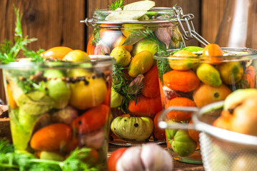 Pickled Tomatoes in Jar with Herbs. Healthy Preserved Food