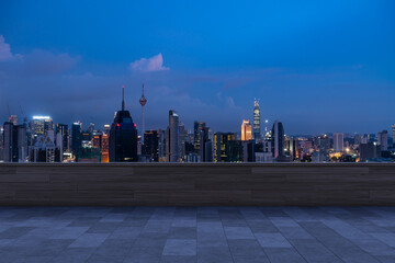 Fototapeta na wymiar Panoramic Kuala Lumpur skyline view, concrete observatory deck on rooftop, night. Asian corporate and residential lifestyle. Financial city downtown, real estate. Product display mockup empty roof