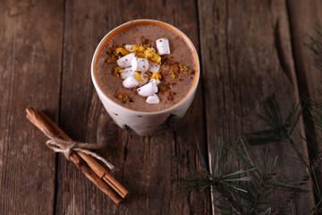 Cocoa with marshmallows and citrus zest on christmas background