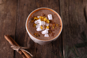 Cocoa with marshmallows and citrus zest on christmas background