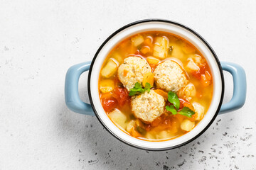 Slow cooker meatball soup in pot. Top view, copy space.