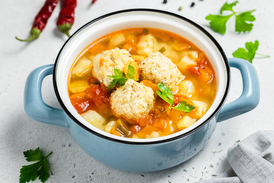 Turkey meatball soup in pot. Copy space.