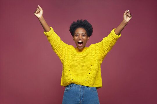 Happy exited african american girl champion rejoice success win, feel euphoric with achievement, shouting, raising hands