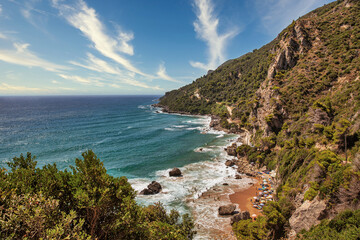 Fototapeta premium Sea waves crashing onto rocks with water splashes. Corfu island, Greece.