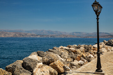 Street lamps on the waterfront in Kassiopi, Corfu island, Greece, - obrazy, fototapety, plakaty