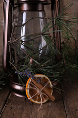 Christmas decorations and coniferous branches on wooden background