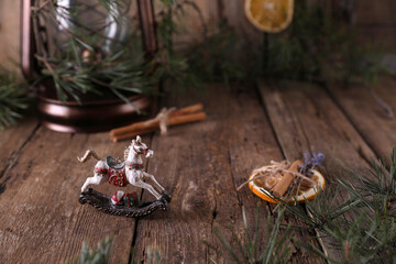 Christmas decorations and coniferous branches on wooden background