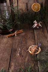 Christmas decorations and coniferous branches on wooden background