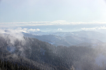 Giumalau Mountains - Romania seen through the fog in winter