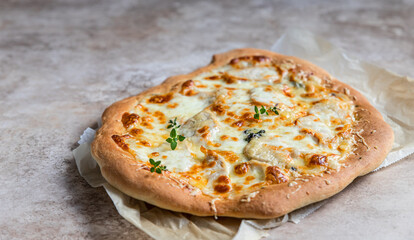 Rome pizza with white chicken meat or turkey and cheese, concrete background. Pinsa. Traditional...