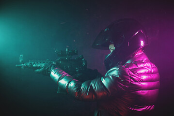 Obraz na płótnie Canvas A cyberpunk motorbiker with the rifle concept.