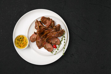 Overhead view of grilled rack of lamb on a plate