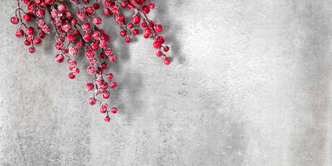 Christmas holiday composition. Red berries on gray background. Xmas, winter, new year concept. Flat...
