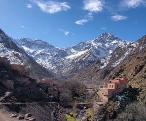 View of the valley leading to a high snowy mountain.