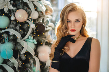 Gorgeous woman near the new year tree. Happy new year and Merry Christmas