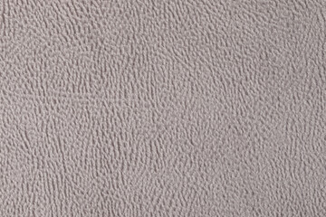 The texture of the fabric. Beige velour close-up. Soft expensive fabric for furniture, curtains, pillows and car upholstery. Background. A place to copy.