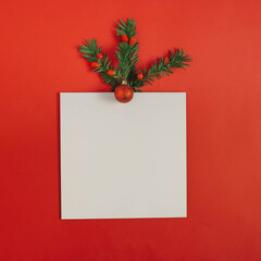 Fototapeta na wymiar White square on a red background decorated with Christmas tree and ornaments