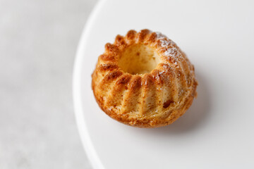 One Muffins with powder on white board, marco and texture. Close-up
