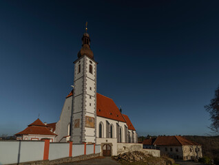 Kajov village with big church with high tower in winter blue sky day