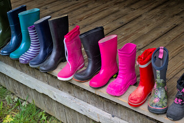 Colored rubber boots on a street market. Safety shoes in different styles and colors. Colorful...
