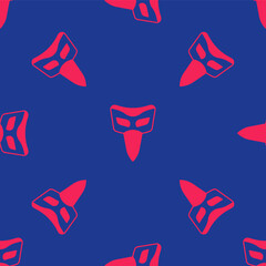 Obraz premium Red Carnival mask icon isolated seamless pattern on blue background. Masquerade party mask. Vector