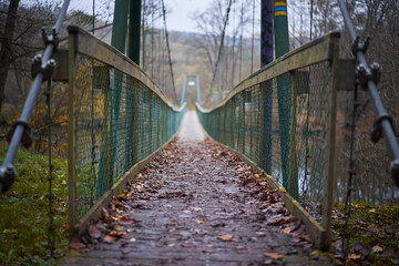 Fototapeta premium Rope bridge or cable bridge on the foot path over the river Dyje in southern moravian region of Czech republic in the beautiful historical vineyard coutryside close to austrian border ideal for hiking