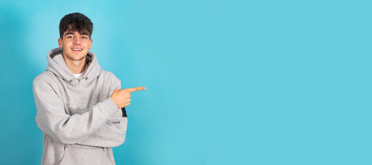 teenager isolated on color background pointing
