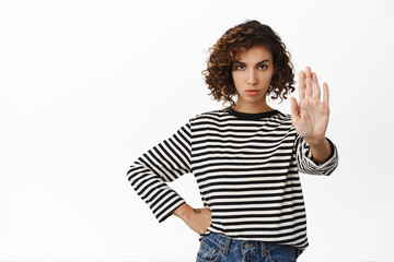 Stop. Serious and concerned young woman disapprove, prohibit action, rejecting, refusing offer,...