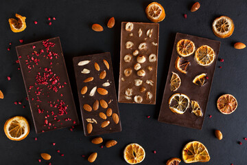 Organic milk and bitter chocolate bars with sublimated berries, orange slices, almond and hazelnut.