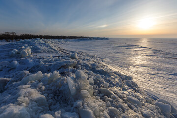 Lake Khanka in the Primorsky Territory in winter. View from above. Frozen coast of a large lake. Arctic landscape. Overall plan. Ice hummocks of a large lake.