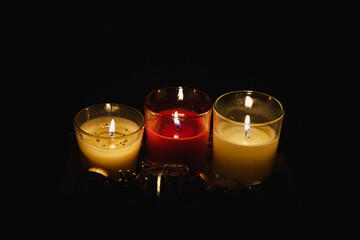 Three Christmas candles decoration glowing in the dark horizontal