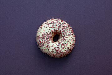 doughnut with cream and chocolate on purple background