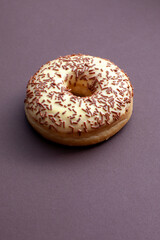 doughnut with vanilla cream and chocolate isolated on brown background