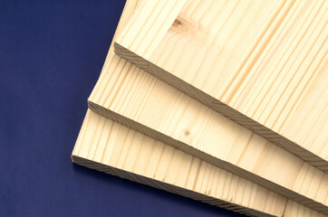 White pine boards cut to the required dimensions and exposed on a blue background.