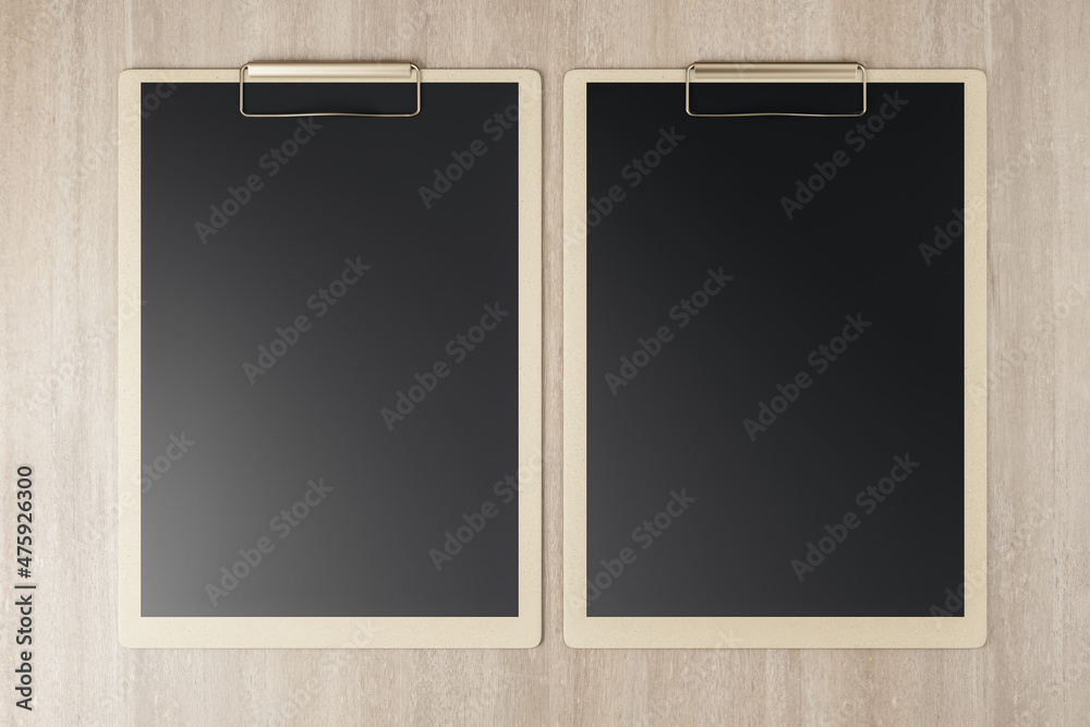 Poster top view and close up of empty black clipboards on wooden backdrop, stationery and mock up supplies 
