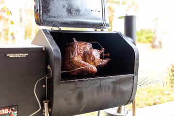 Turkey inside smoker cooking for holiday dinner