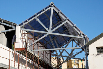 Fototapeta na wymiar Load bearing structure of an industrial roof under construction