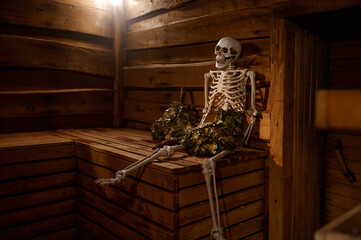 Skeleton steaming with oak broom in sauna