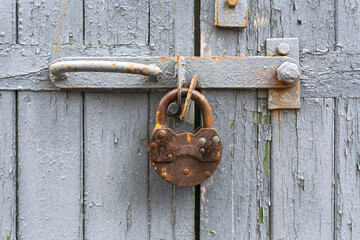 Wooden planks old with cracked paint and lock