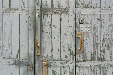 Old wooden boards with cracked paint and handles