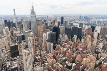 Fototapeta na wymiar Aerial panoramic city view of Upper Manhattan area, the East Side, river and Brooklyn neighborhoods on horizon, New York city, USA. Iconic cityscape of building exteriors of NYC