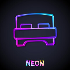 Glowing neon line Big bed for two or one person icon isolated on black background. Vector