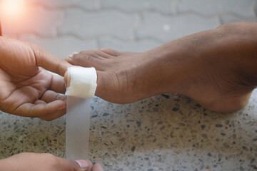 Close – up Asian child feet with an adhesive. Foot first aid, plaster.photo Hospital and first...